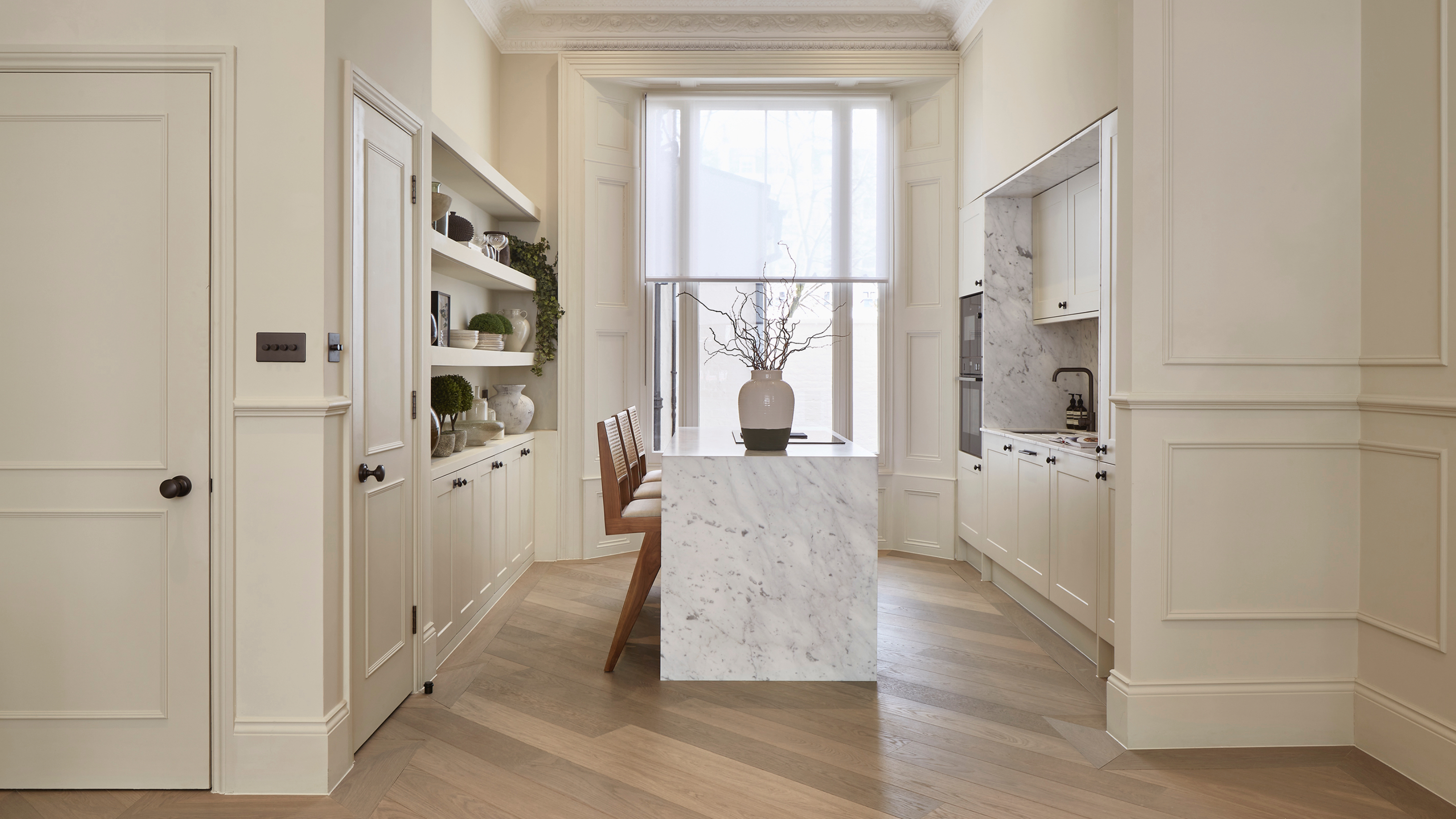 Rich hardwood flooring with warm oak tones running through a kitchen