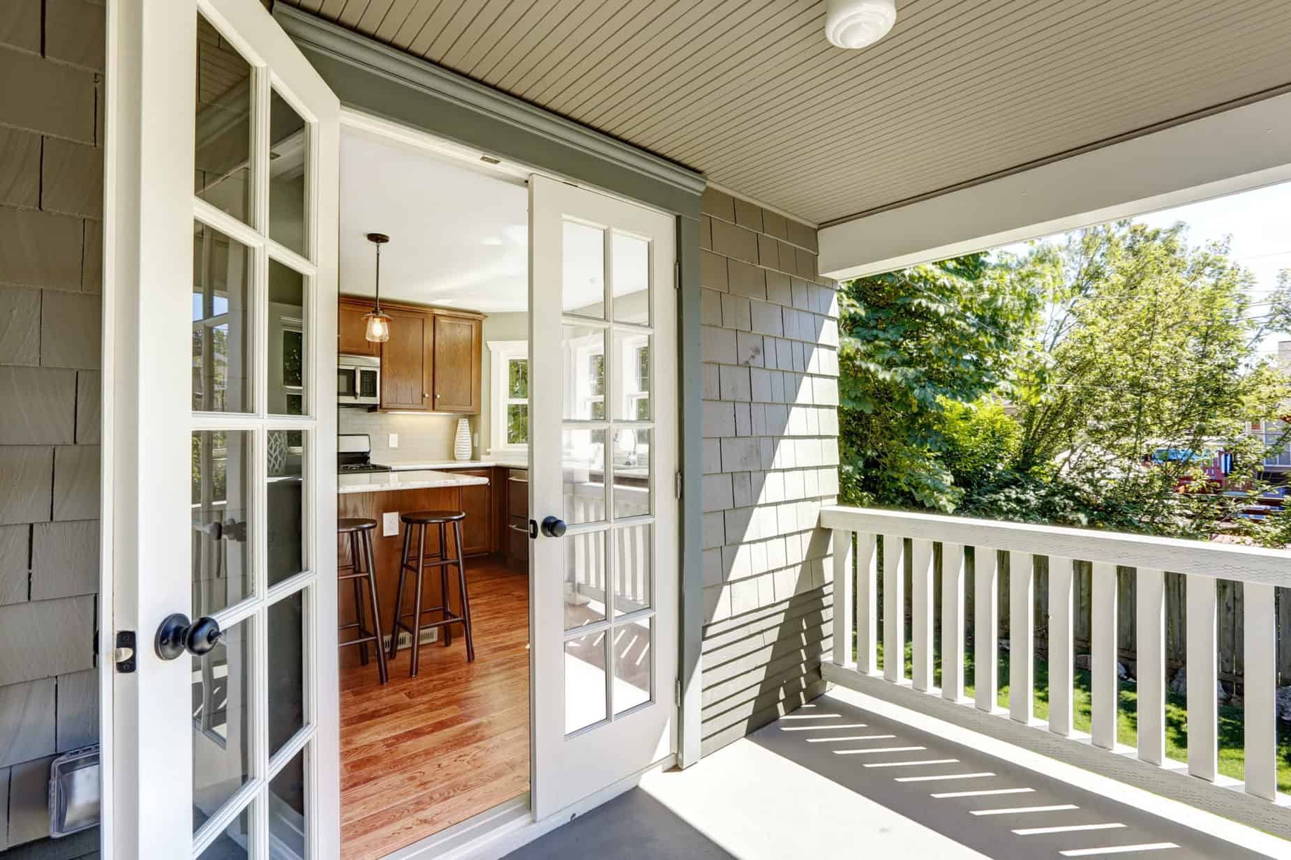 French doors leading from a kitchen to an outdoor patio and garden area
