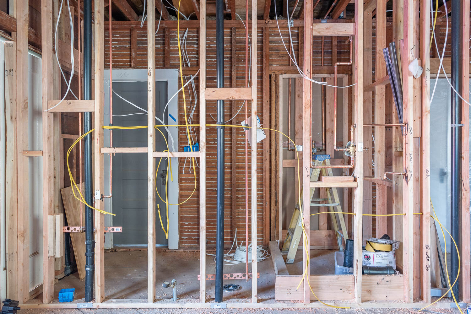 Kitchen plumbing supply lines and drain pipes during rough-in installation