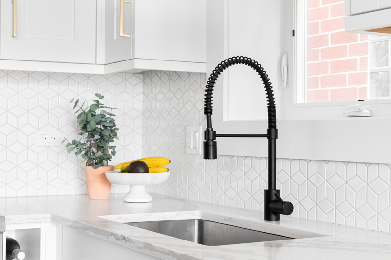 Modern undermount kitchen sink with brushed nickel faucet installed in a countertop