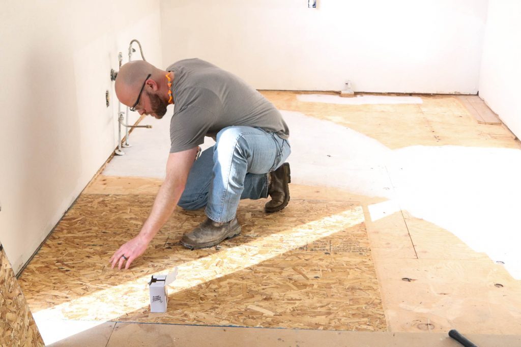 Kitchen subfloor being prepared and leveled during a renovation project