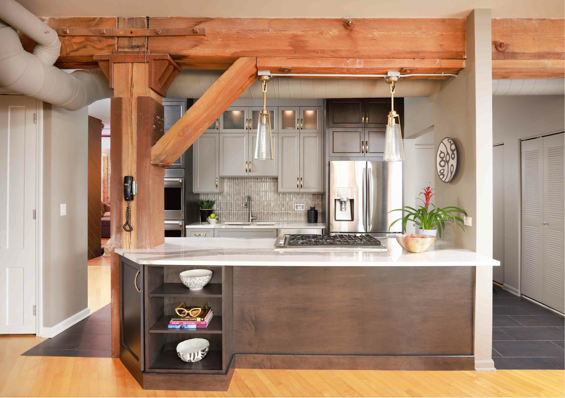 Open concept kitchen with exposed structural beam where a wall was removed during remodeling